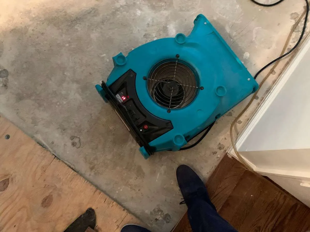 Air mover drying subfloor during Commercial Water Damage Restoration in Lehighton